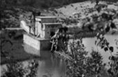 Dredge No. 4 by Alfred Burgoyne. Symbolizes importance of dredging operations (1899-1966) with the evolution of gold mining in the Klondike Bonanza Creek, Yukon.